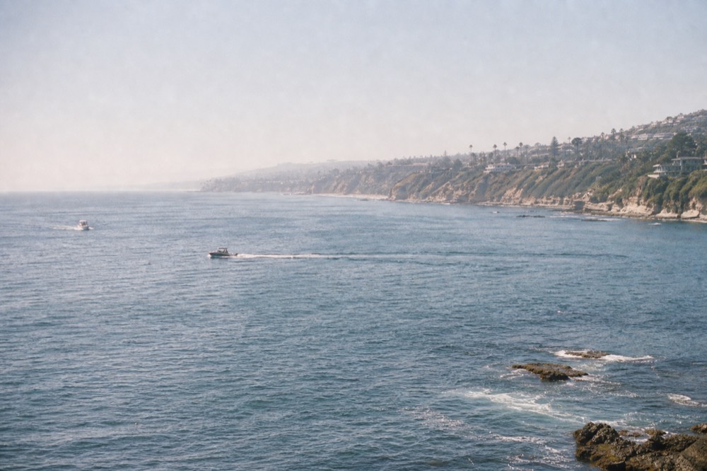 Open Pacific water and a hazy coastline stretching south from San Diego, late-morning light