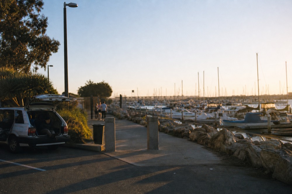 Waterfront parking and the walk toward San Diego's boat piers at golden hour, long shadows and warm low light