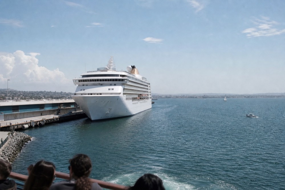 A large white cruise ship at the San Diego Embarcadero terminal, late-morning light
