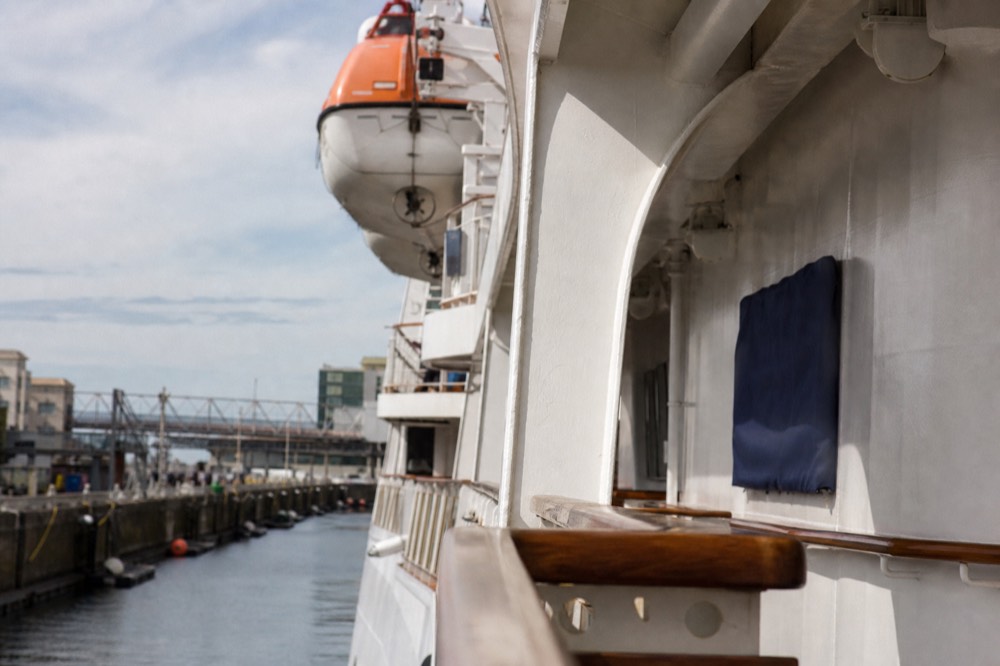 A large white cruise ship at the San Diego Embarcadero terminal, shallow depth of field, textures sharp